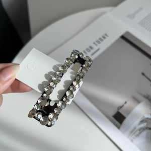 Close-up of sparkling rectangle rhinestone BB hair clip on a nyunyu display card