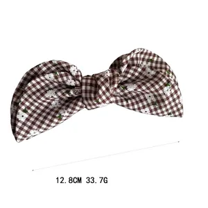 Plaid ribbon banana clip with floral pattern in brown and white fabric bow