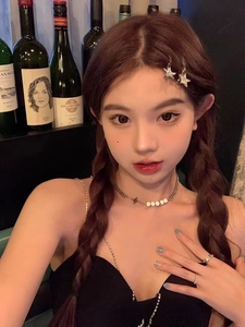 Détail de pinces à cheveux étoiles avec strass et collier assorti sur un modèle