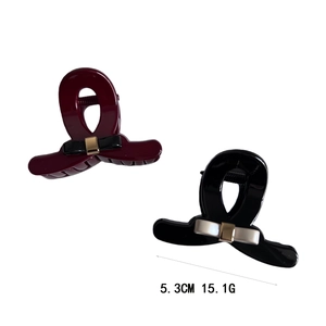 Elegant medium bow hair claw clips in burgundy and black resin with gold metal accents