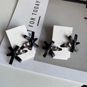 Chic black leather bow hair clips with sparkling rhinestones set of four on card
