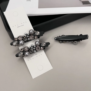 Elegant rhinestone and pearl hair clips set with shimmering grey crystals and beads