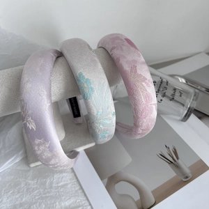 Three-piece set of embroidered satin headbands in pastel colors with floral patterns