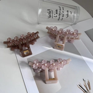Three elegant flower hair claws with pearls in brown and pink acrylic material