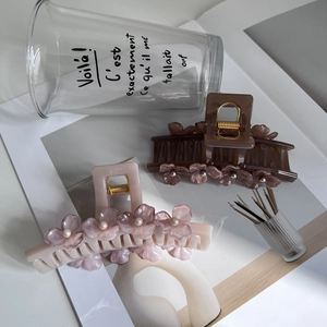 Detail of cream and brown flower hair claws with pearls and metal spring