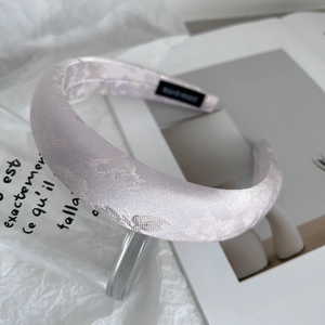 Detail of light purple satin embroidered headband with thick sponge and inner label