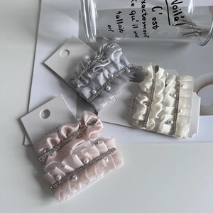 Elegant fabric pleated hair clip set with sparkling rhinestones and pearls on white card