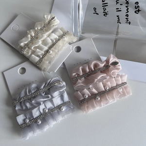 Elegant fabric pleated hair clips set with pearls and rhinestones on white display cards