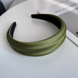 Close-up of grass green satin headband with fabric texture and non-slip inner lining