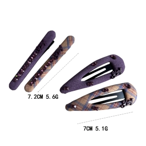 Elegant purple plaid hair clips set with rhinestones and metal accents on white background