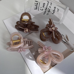 Elegant hair claw clips set with bow design, pearls, and floral rhinestones for women