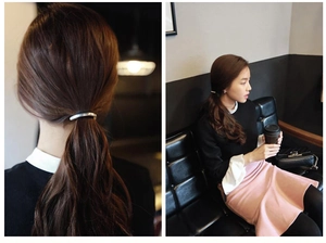 Polished silver ponytail cuff showing hair accessory in a modern lifestyle setting
