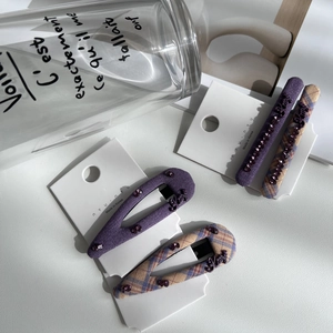 Purple fabric plaid hair clips set with sparkling rhinestones and Kitty lettering