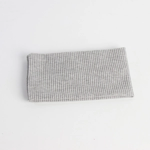 Detailed macro view of the grey ribbed knit headband texture and elastic fabric pattern