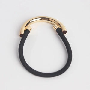 Minimalist black elastic hair tie with a polished gold semi-circle metal buckle detail