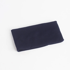 Macro detail of elastic navy blue knitted headband showing vertical ribbed texture