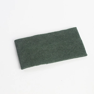 Macro shot of dark green knitted headband showing the ribbed fabric texture and elastic weave