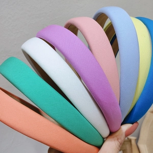 Close-up of eight colorful padded fabric headbands arranged in a decorative fan shape