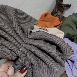 Close-up of ribbed knit texture on wide elastic headbands in various autumn colors