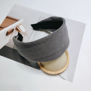 Detail view of dark grey ribbed knit headband showing thick texture and inner black lining
