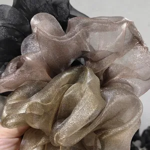 Three-piece metallic organza scrunchie set in black, brown and gold for elegant hair styling