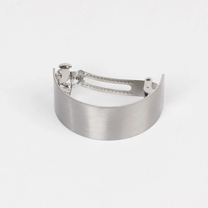 Detail of minimalist arched metal hair clip featuring a fine silver brushed texture surface