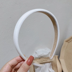 Close-up of white satin headband with soft sheen and anti-slip lining detail