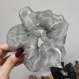 Close-up of grey pearlescent organza scrunchie showing fabric texture and large size