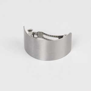 Detail view of the brushed silver metal curved hair clip with a spring mechanism