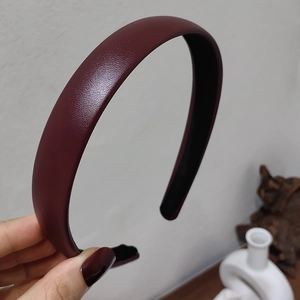 Close-up of deep burgundy headband featuring premium lychee texture leather finish