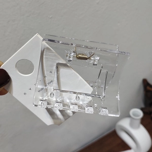 Detail of large transparent rectangular hair claw clip with strong metal spring