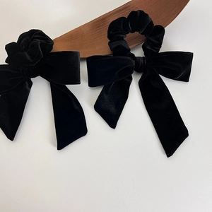 French velvet bow hair scrunchies in black, featuring long tassels on a white background