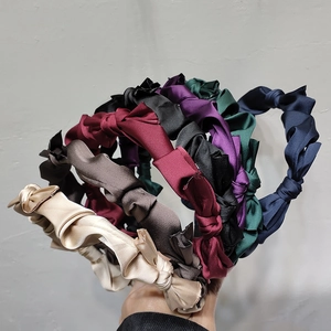 Elegant satin twisted headband set in seven classic colors with a glossy silk finish