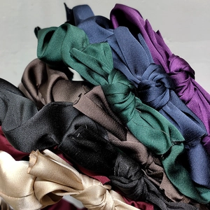 Elegant satin knotted headbands in various vintage colors with a silky pearl luster finish