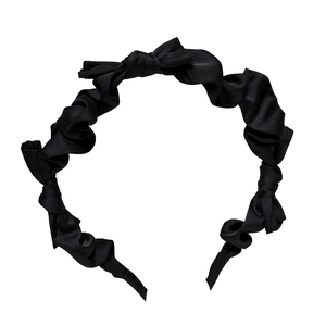 Elegant black satin scrunchie headband with delicate bows on a white background