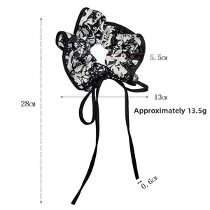 Detailed view of floral satin scrunchie with long ribbons and product dimensions