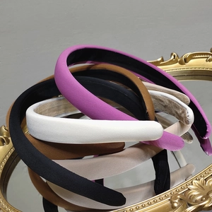 Chic padded sponge headbands in satin fabric displayed on a vintage gold mirror