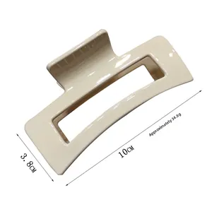 Detail view of cream rectangular hair claw clip measuring 10cm by 3.8cm with metal spring