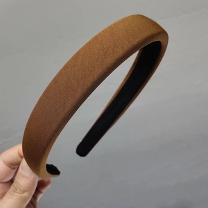 Detail of brown twill fabric texture on a thick padded sponge headband accessory