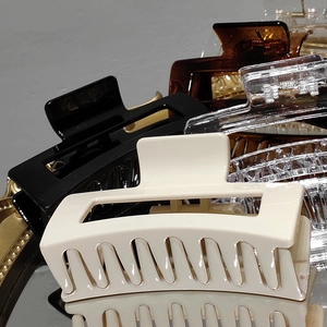 Rectangle hair claw clips set in various colors on a mirror tray for thick hair