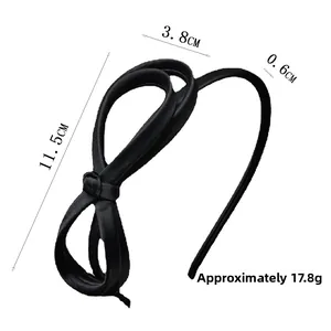 Detail view of black satin bow headband with precise dimensions and lightweight design