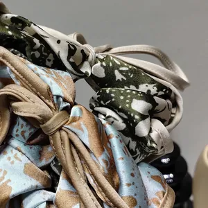 Elegant floral print satin scrunchies featuring dark green and light blue digital patterns