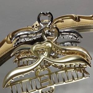 Elegant metal heart claw clip for hair styling in polished silver and matte gold finishes
