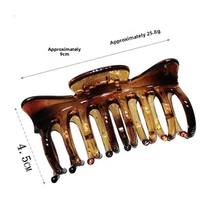 Detail view of amber hair claw clip with measurements showing 9cm length and 4.5cm height