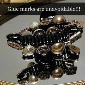 Elegant vintage hair claw clip with rhinestones and gold perfume plaque on mirror