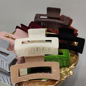 Elegant flocked hair claws set in various colors on a golden vintage mirror tray