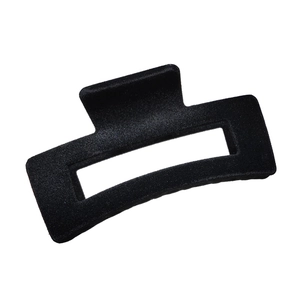 Detailed view of the black flocked rectangular claw clip with a hollow design on white back