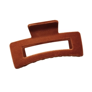 Detailed view of large rusty red flocked hair claw clip with rectangular cutout design