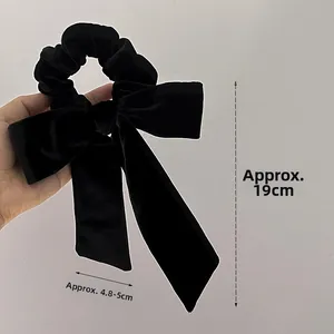 Detail view of the black velvet bow scrunchie showing measurements 19cm by 5cm