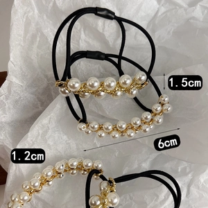 Detailansicht von Perlen-Haargummis mit Goldkette und elastischem Band im Retro-Stil